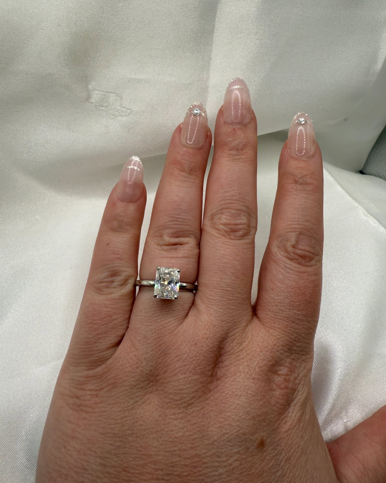 Nicole Solomon Facebook ad: 2.5ct radiant cut moissanite solitaire engagement ring…