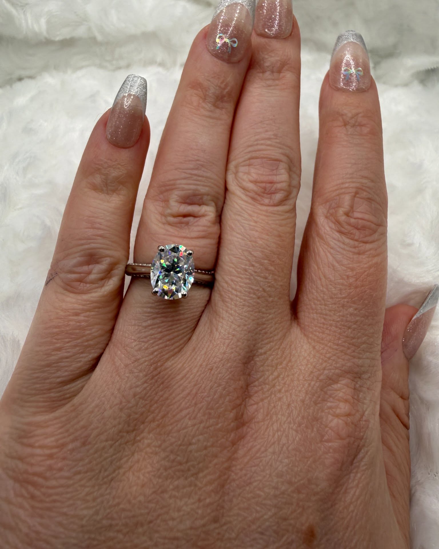 Nicole Solomon Facebook ad: 3ct oval moissanite engagement ring with side accent…