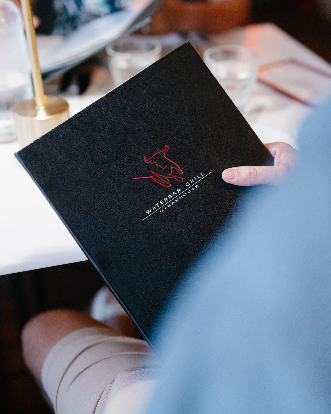 Waterbar and Grill Steak House Facebook ad: That moment you sit down, marina breeze, first…