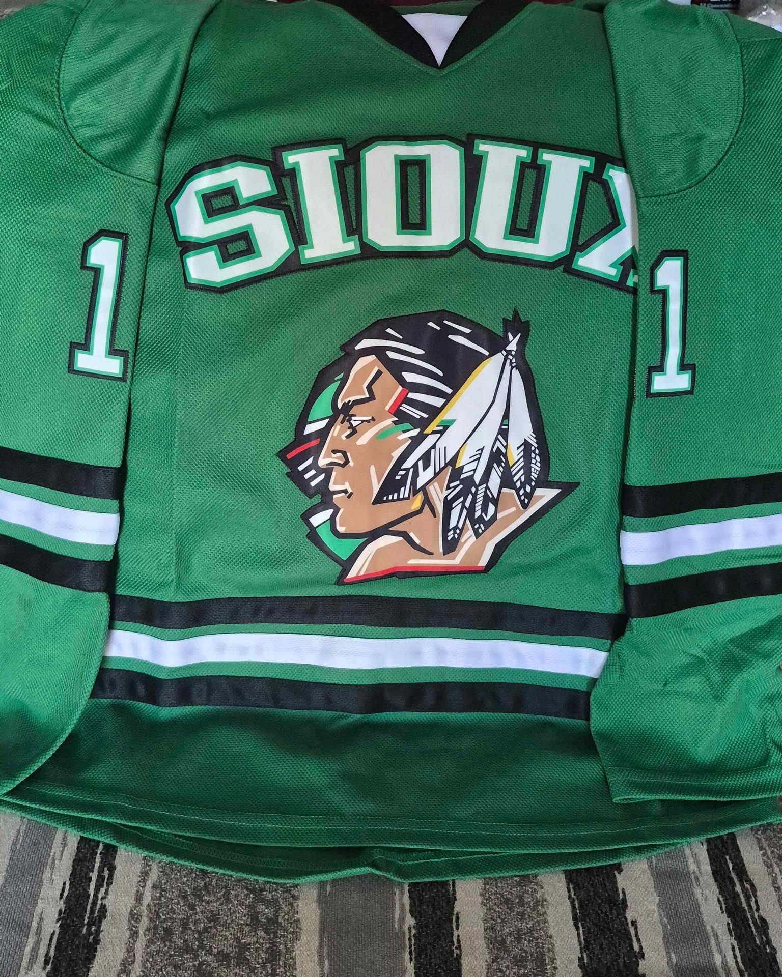 Aron Kaufenberg Facebook ad: Green Sioux Parise Hockey Jersey #11 Size large & medium