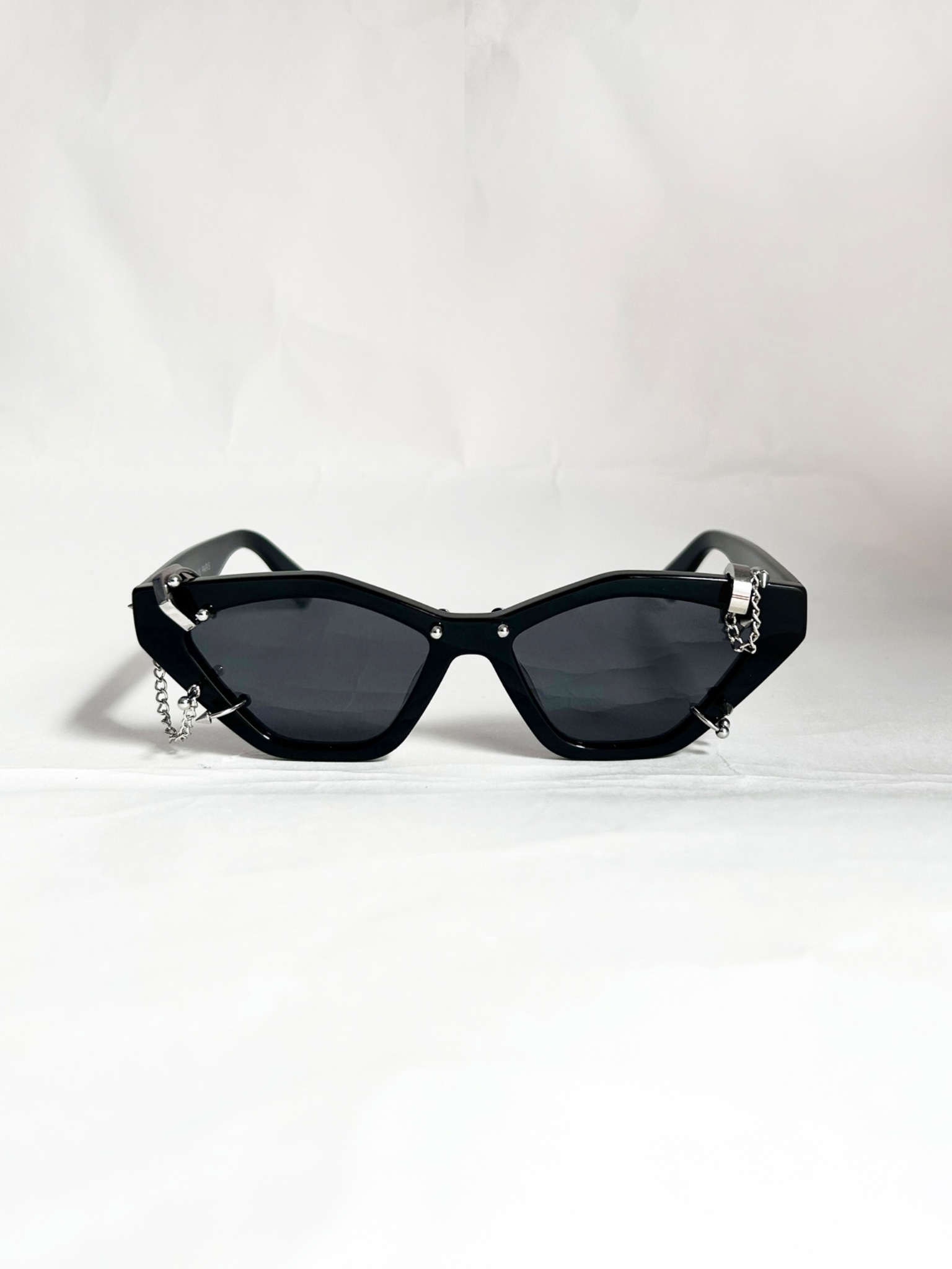 Arcus Facebook ad: Sunglasses with piercings.