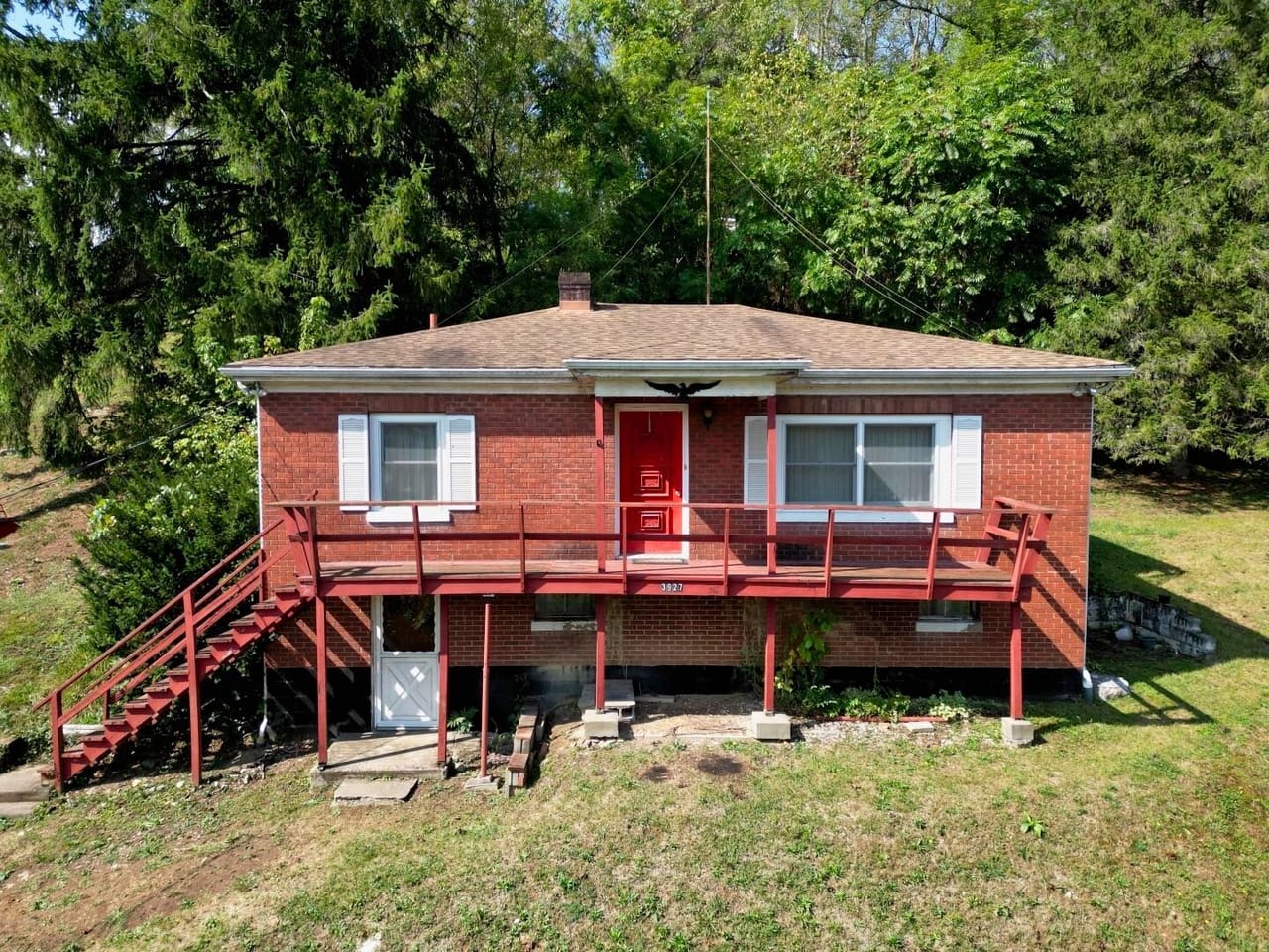Bauer Realty & Auctions Facebook ad: Charming brick home on 1 acre with hillside…