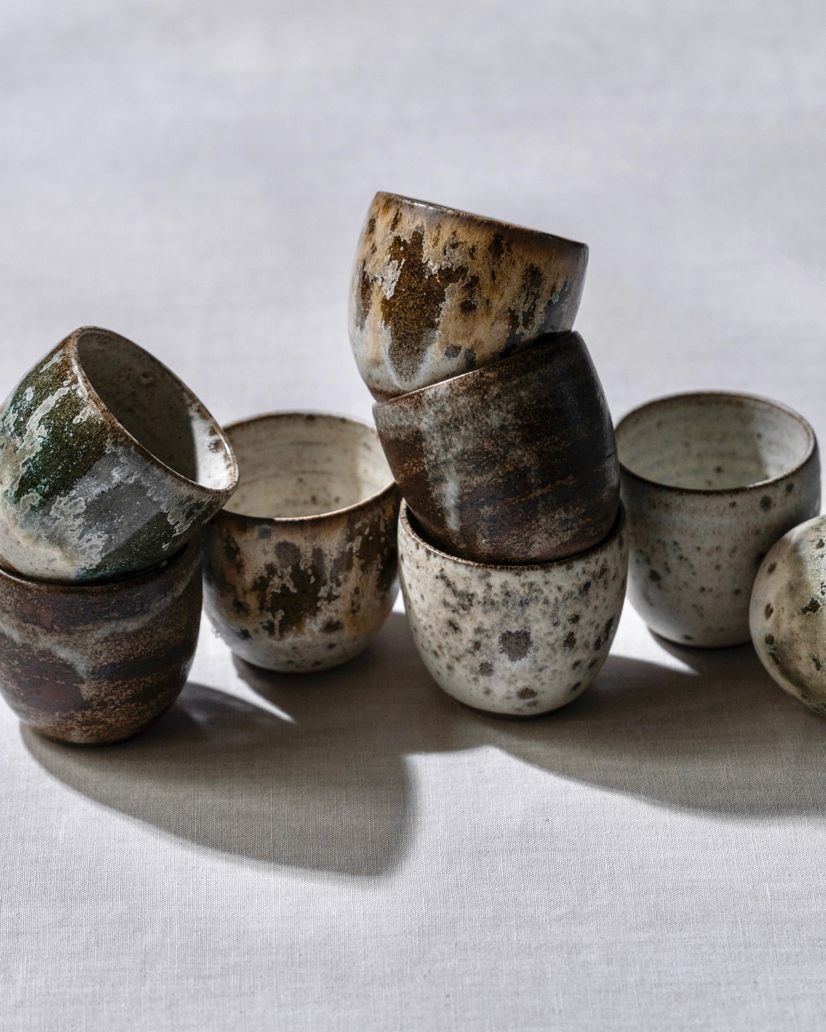 Artifactt Facebook ad: Rows of small cups, no two alike.
