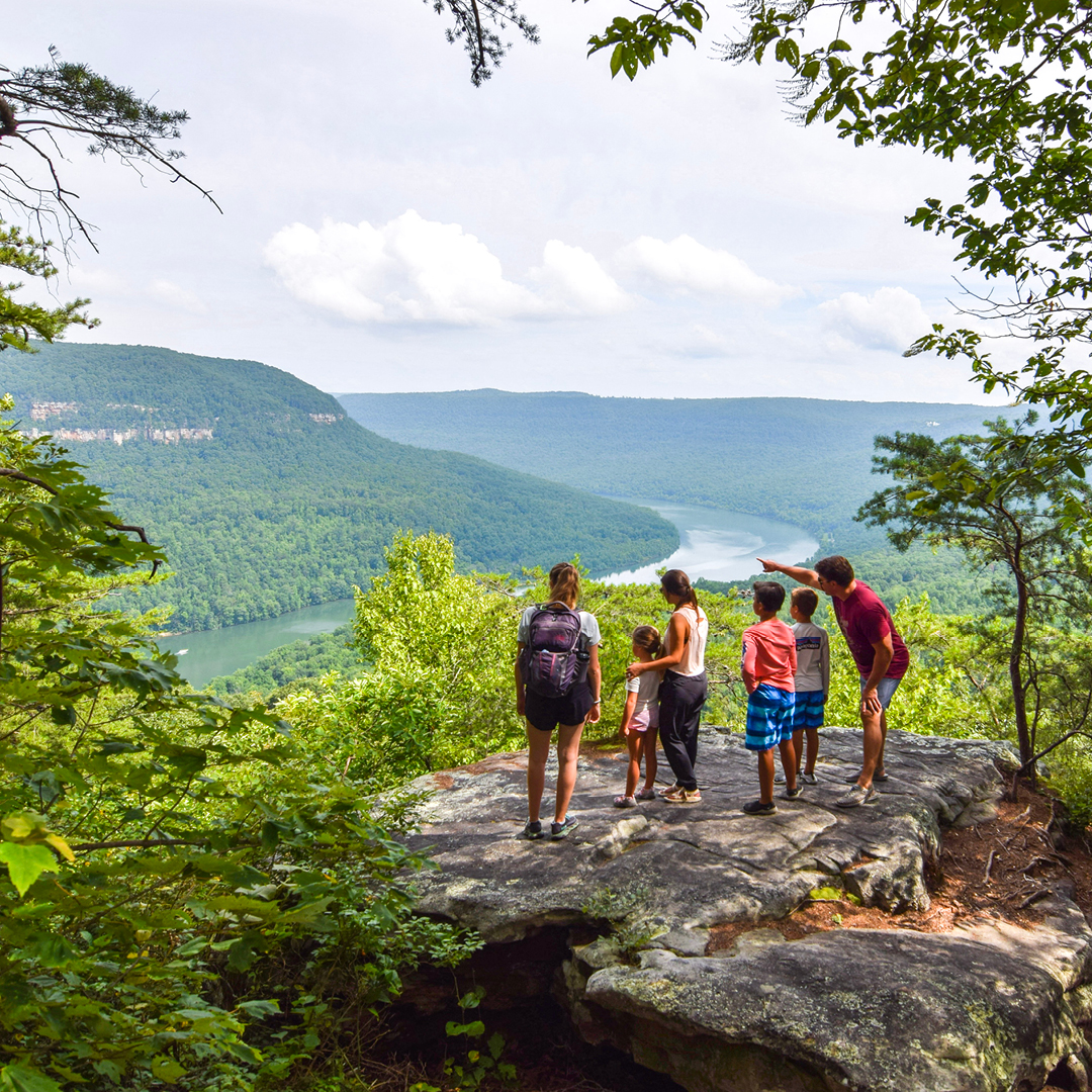 Visit Chattanooga Facebook ad: Chatt Spring is doing its thing-green hills, rushing…