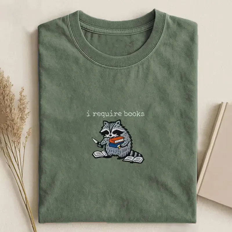Shawncraftstudio Facebook ad: I Require Books Raccoon Embroidered T-shirt