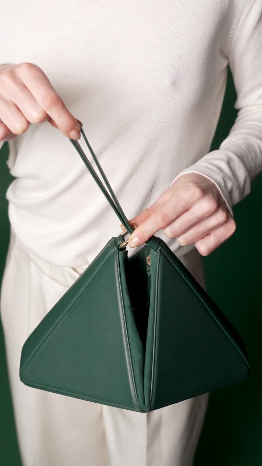 Mlouye Facebook ad: Our architectural, origami inspired shoulder bag, now has…