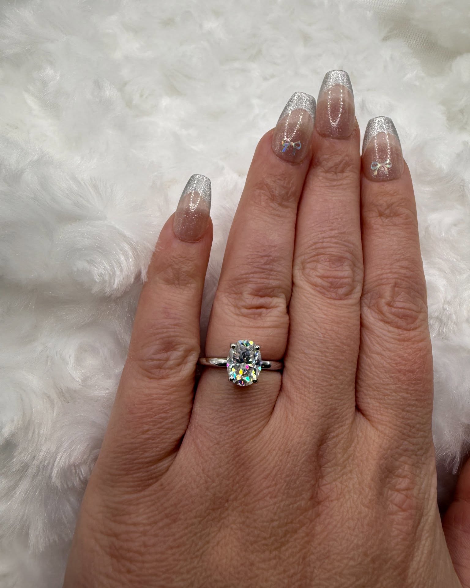 Nicole Solomon Facebook ad: 2ct oval moissanite engagement ring with hidden halo