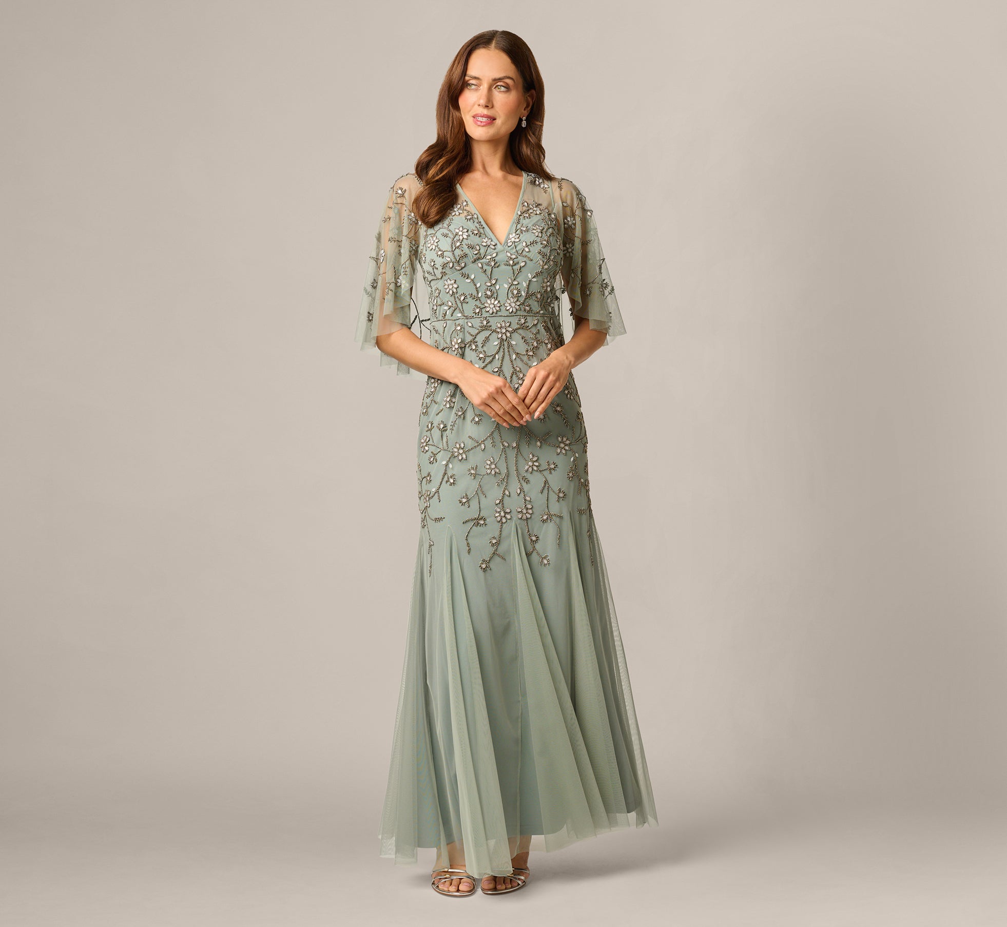 Adrianna Papell Facebook ad: Green Cape Sleeve Opaline Floral Beaded Mermaid Gown…