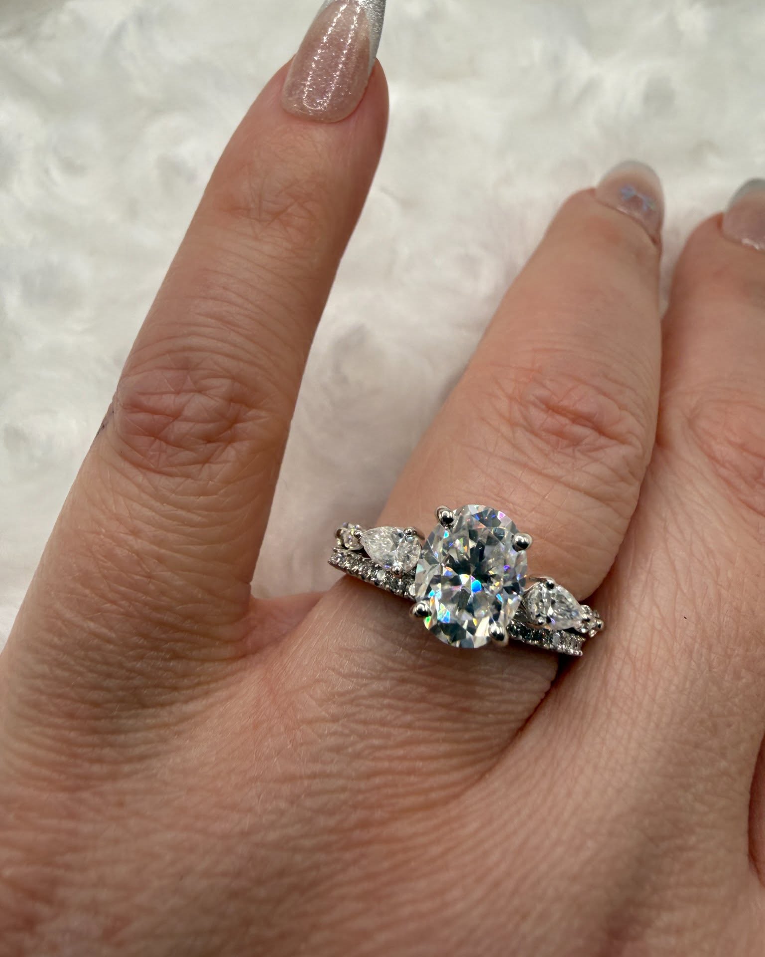 Nicole Solomon Facebook ad: 2 carat oval moissanite with pear accent stones - wedding…