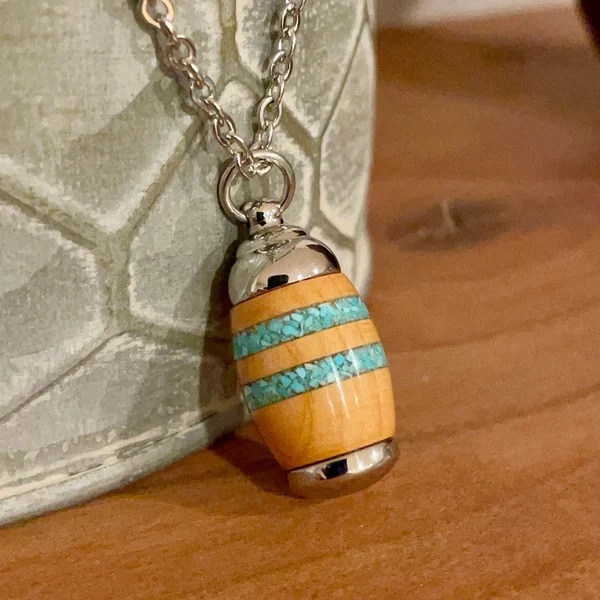 Ashes 2 Ashes Memorials Facebook ad: Wood & Stainless Steel Cremation Jewelry